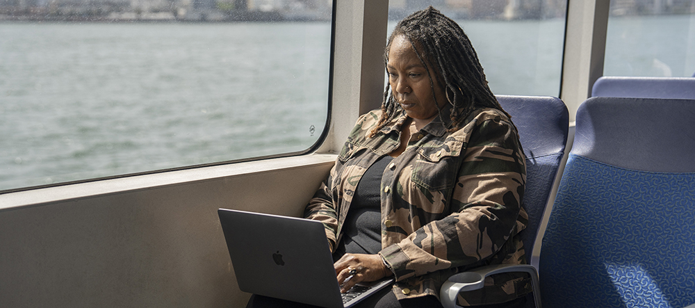 Passenger using laptop on ferry